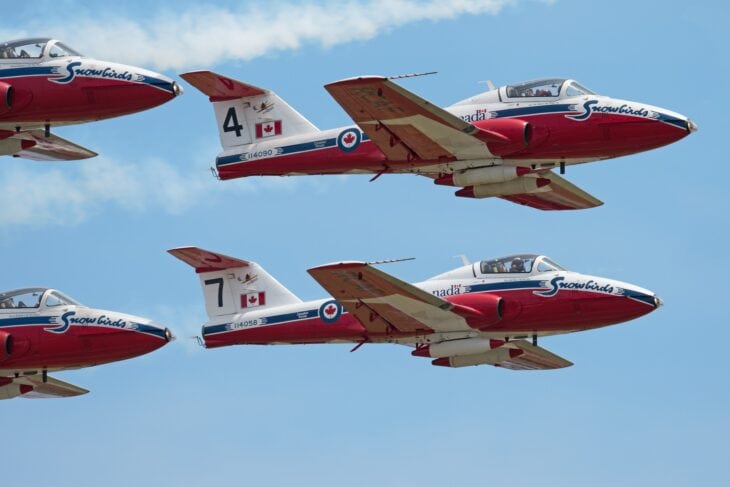 Two Canadian Snowbirds CT-114 Tutor jets flying in close formation
