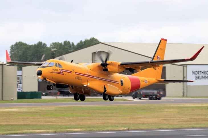 RCAF CC-295 Kingfisher in search and rescue orange climbing out after takeoff