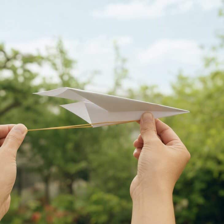 A stretched rubber band gives every launch the same push.