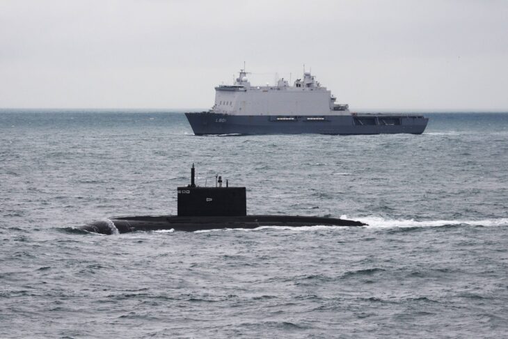 Russian Kilo-class submarine on the surface with a Dutch ship behind