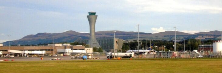 Edinburgh Airport control tower and airside buildings with hills beyond