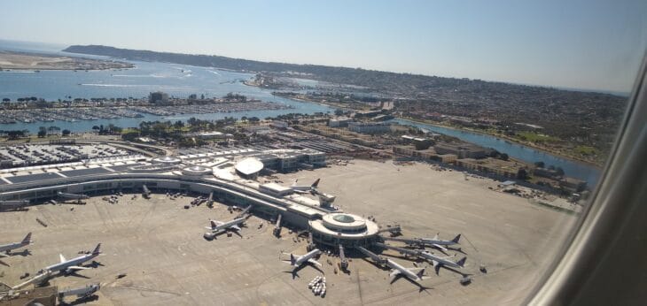 Aerial view of San Diego International Airport's terminal and apron beside the bay