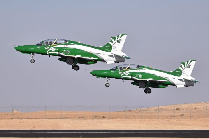 Two Royal Saudi Air Force Hawk 165 jets in Saudi Hawks green and white colors taking off together