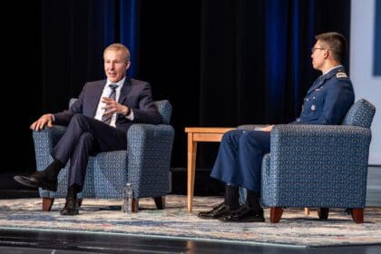 United Airlines CEO Scott Kirby seated on stage in conversation at the Air Force Academy leadership symposium in 2024