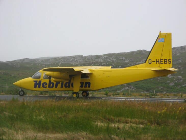 Yellow Hebridean Air Services Britten-Norman Islander G-HEBS on the grass-edged runway at Colonsay