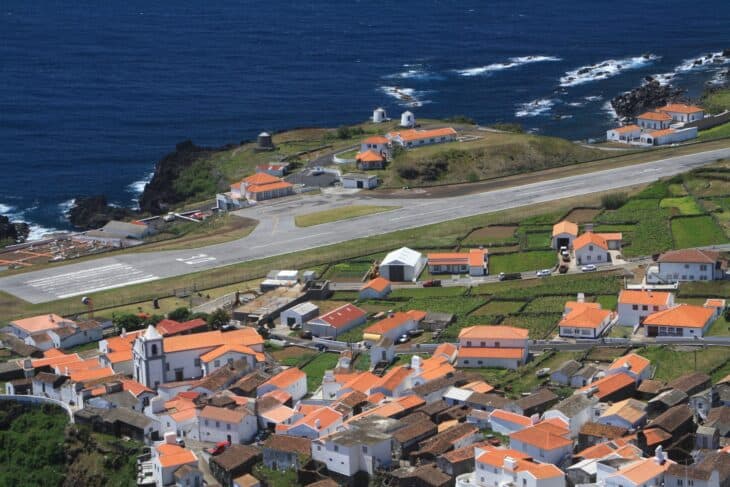 Corvo's runway running along the cliff edge beside the red-roofed village of Vila do Corvo