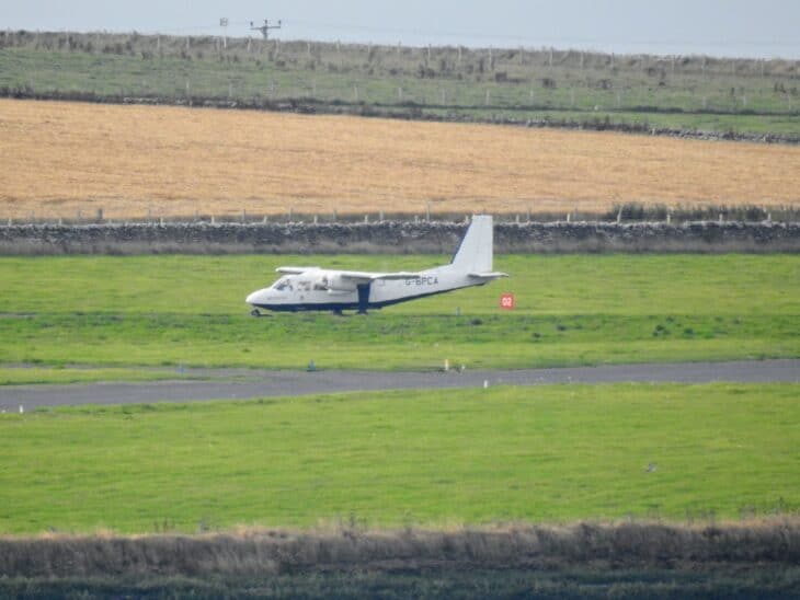 Britten-Norman Islander on the grass and gravel runway at Stronsay Airport, Orkney