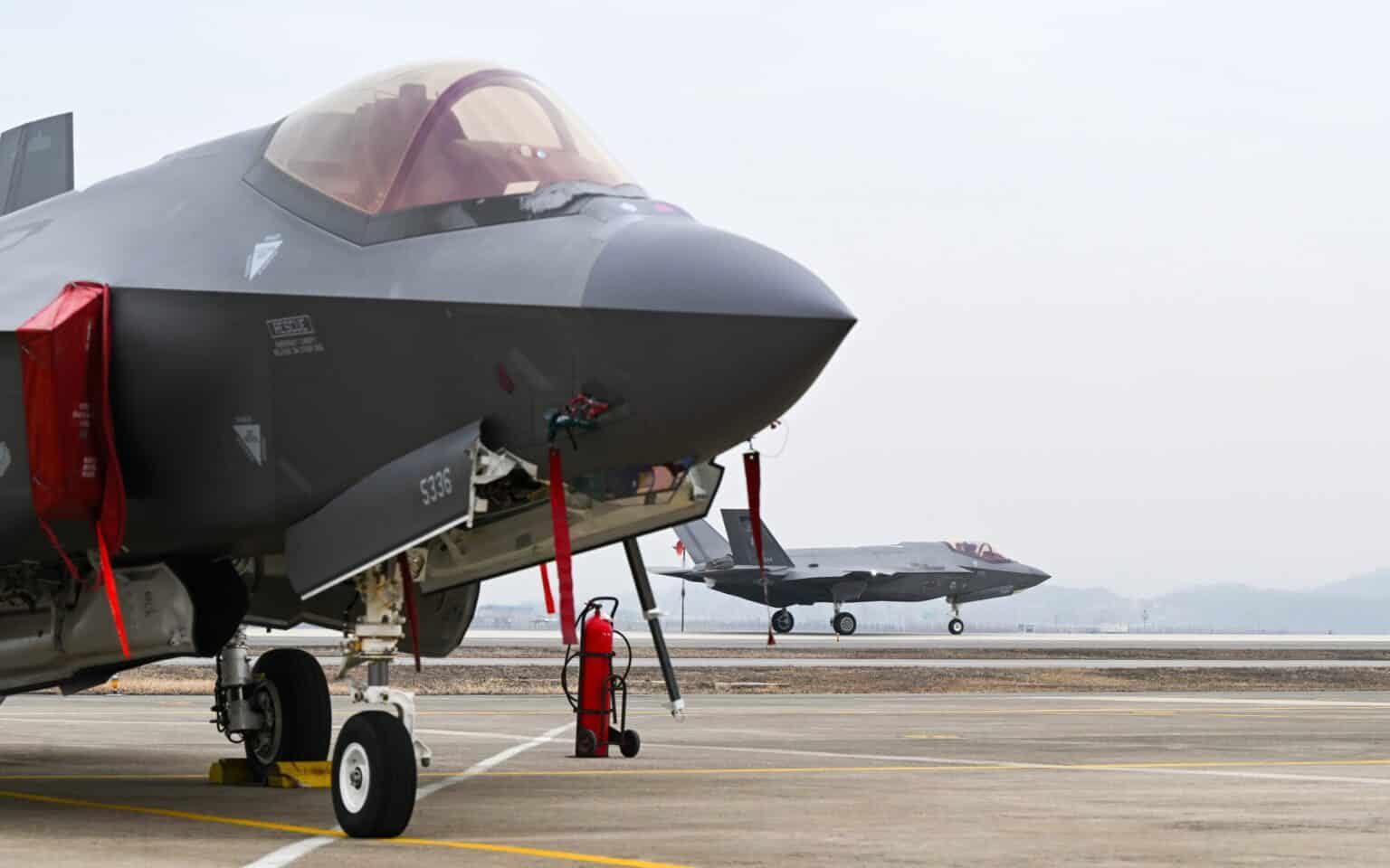 Close-up of the nose of an F-35A Lightning II parked on a South Korean ramp with a second F-35A taxiing behind it