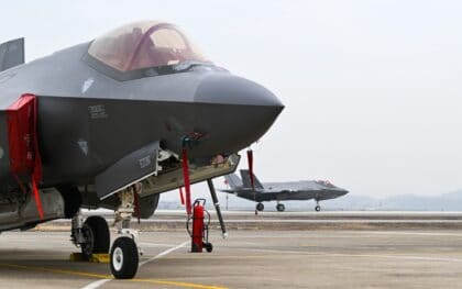 Close-up of the nose of an F-35A Lightning II parked on a South Korean ramp with a second F-35A taxiing behind it