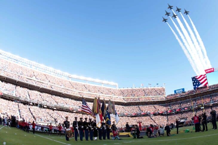 Blue Angels F/A-18 Hornets in a diamond with smoke trails above Levi's Stadium during the Super Bowl 50 flyover