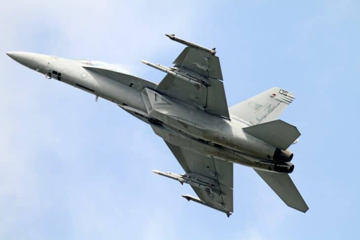 F/A-18F Super Hornet banking away with external stores under the wings and fuselage