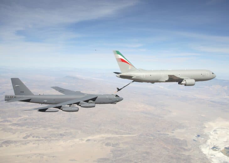 Italian Air Force KC-767 tanker refueling a USAF B-52H bomber over desert terrain