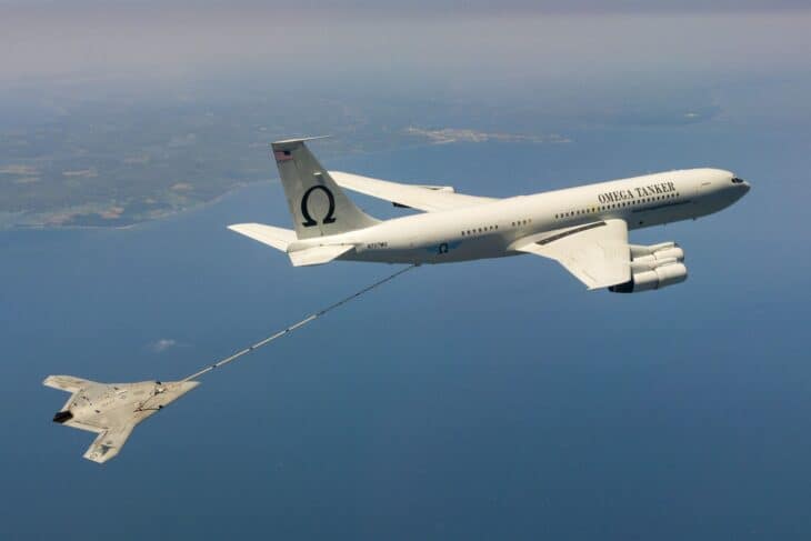 Omega Air Boeing 707 tanker refueling a Navy X-47B unmanned aircraft over water