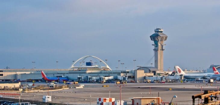 Los Angeles International Airport with the control tower and Theme Building behind the airfield