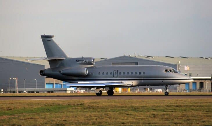 Grey Dassault Falcon 900B N898TS taxiing past a hangar