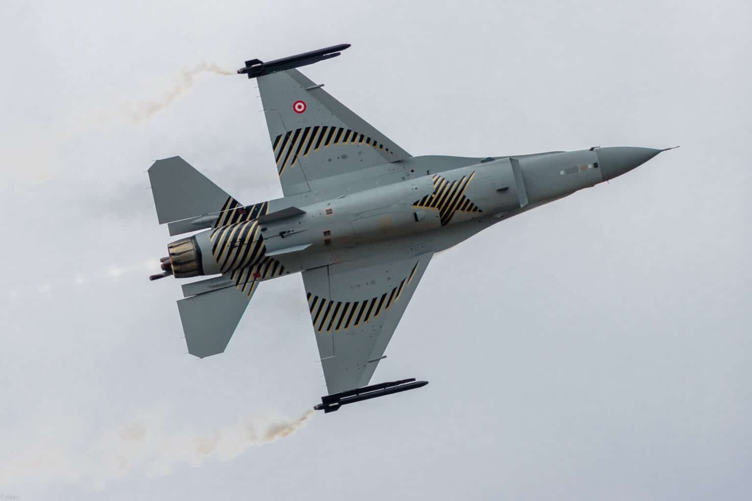 Turkish Air Force SoloTürk F-16 in striped display livery banking with missiles on its wingtips