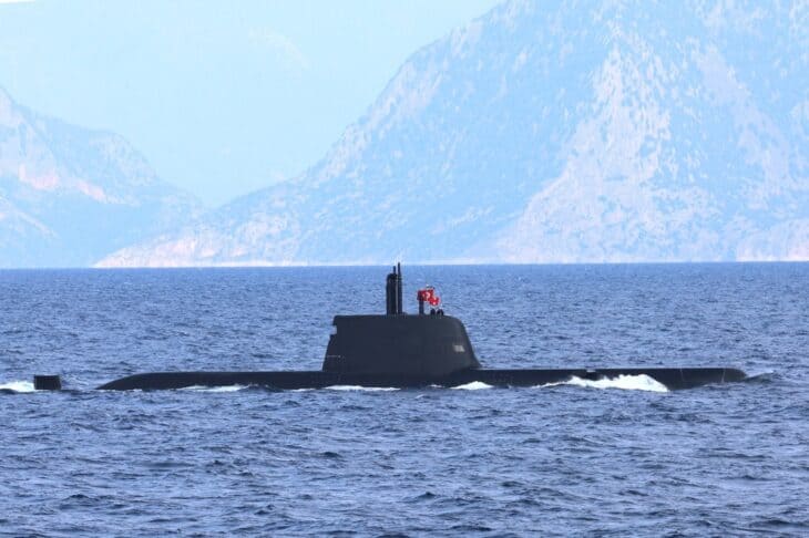 Turkish Reis-class submarine TCG Piri Reis surfaced off a rocky coast
