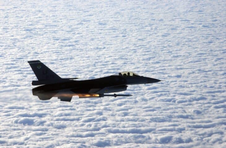 F-16C Fighting Falcon firing an AIM-120 AMRAAM above a layer of cloud