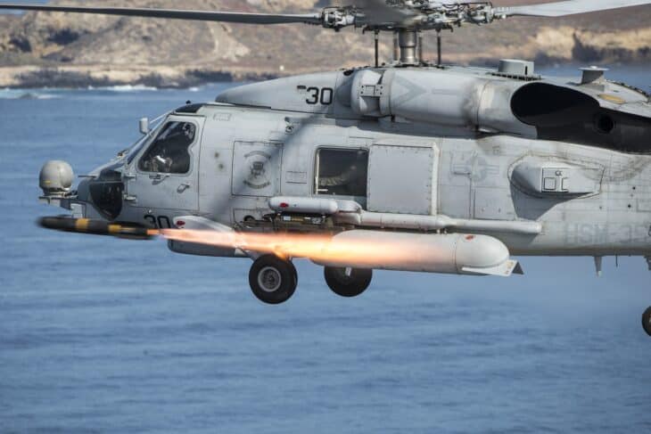 MH-60R Sea Hawk helicopter firing an AGM-114 Hellfire missile over the ocean
