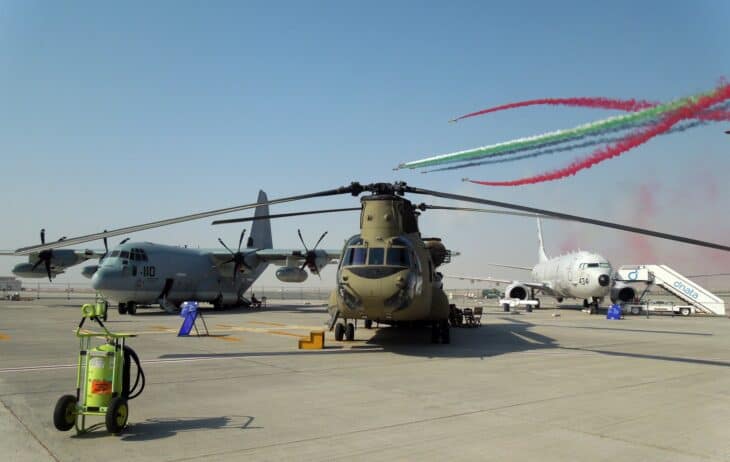 CH-47 Chinook on the ramp at Dubai Airshow 2015 with Al Fursan smoke trails behind