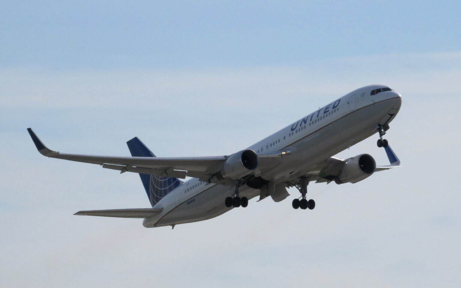 United Airlines Boeing 767-300 N644UA climbing out after takeoff with landing gear still extended