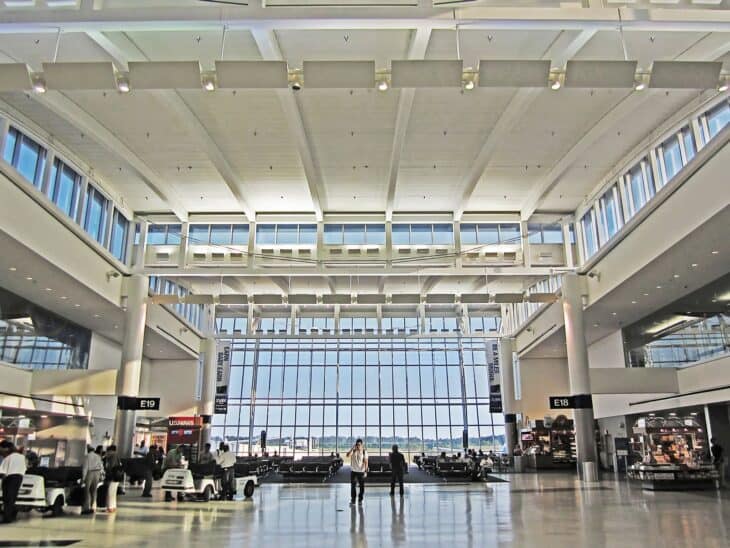 Bright atrium of Terminal E at Houston's George Bush Intercontinental Airport with large windows onto the ramp