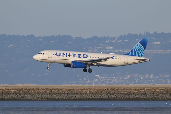 United Airlines Airbus A320 N451UA on final approach over the bay shoreline at San Francisco
