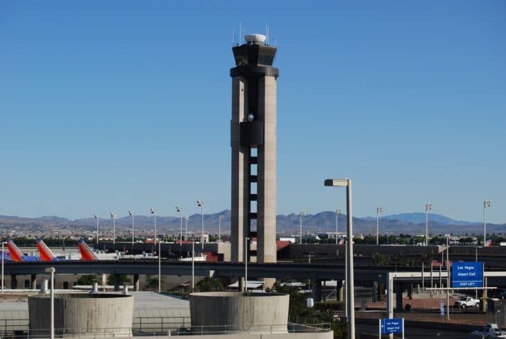 Air traffic control tower rising above the ramp and gates at Harry Reid International Airport in Las Vegas