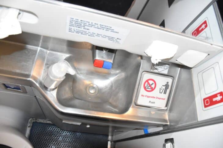Stainless steel lavatory sink and wall panel inside a Ukraine International Airlines Boeing 737