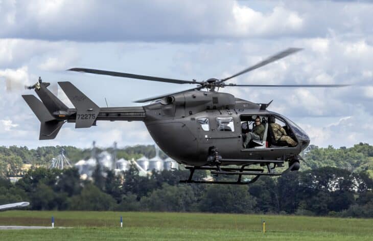 US Army UH-72A Lakota hovering over a grass airfield
