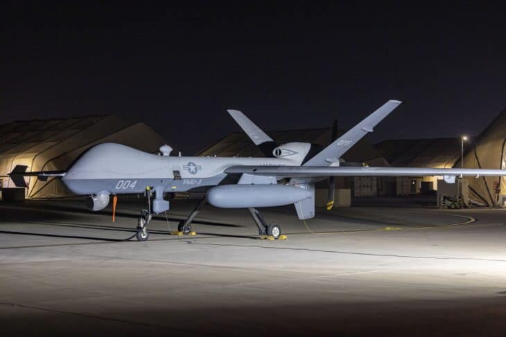 Marine Corps MQ-9A Reaper of VMU-3 on a floodlit flight line at night