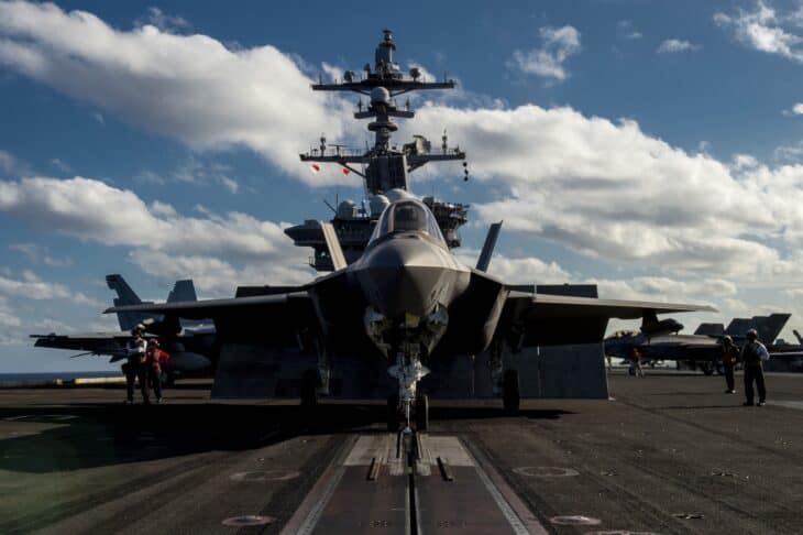 F-35C Lightning II head-on on the flight deck of USS Carl Vinson with the island behind it