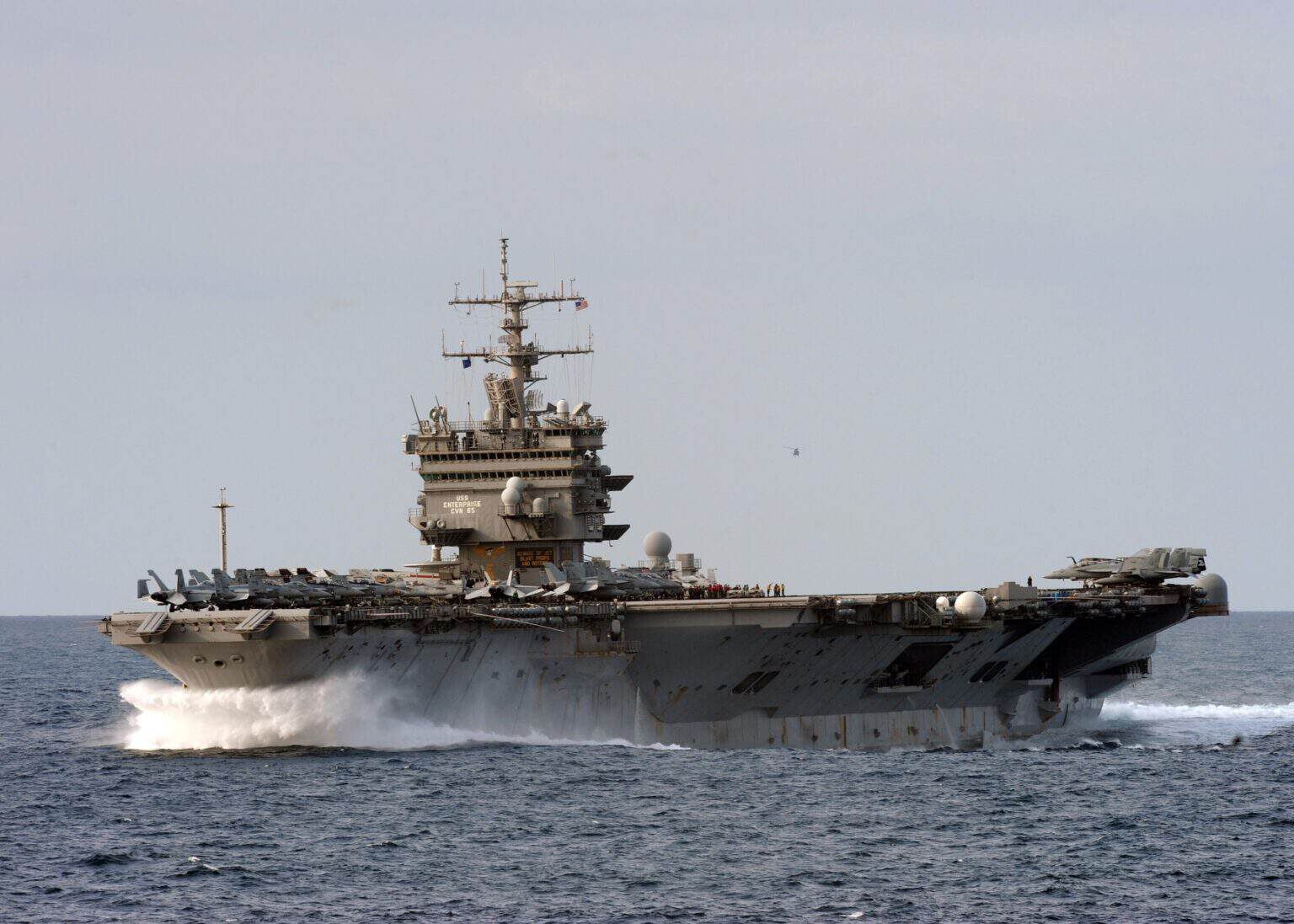 USS Enterprise CVN-65 steaming at speed with a white bow wave