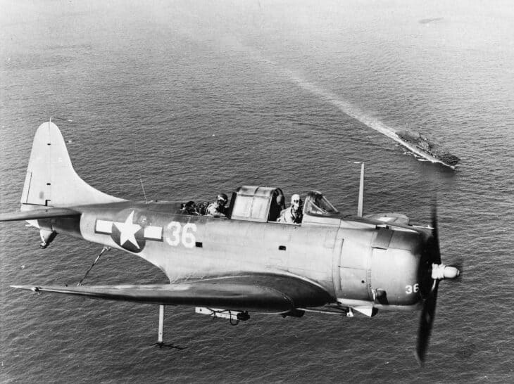SBD Dauntless dive bomber over USS Enterprise in 1944