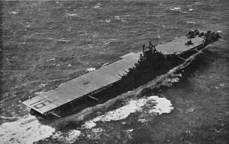 Aerial view of USS Lexington (CV-16) at sea with the number 16 painted on the flight deck