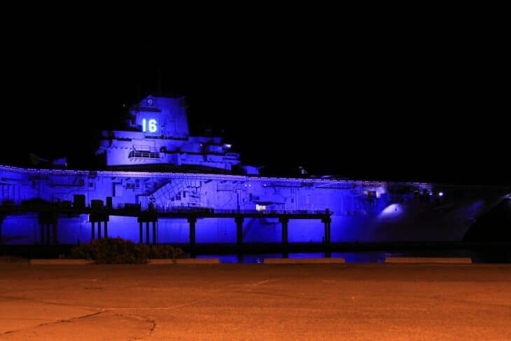USS Lexington (CV-16) lit in blue at night at its berth in Corpus Christi, Texas