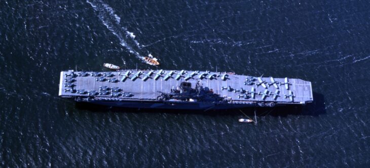 Aerial view of USS Wasp (CV-7) at anchor with aircraft parked on her flight deck