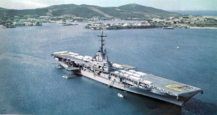 The antisubmarine carrier USS Wasp (CVS-18) at anchor in a harbor in 1958, showing the angled flight deck added in her postwar modernization