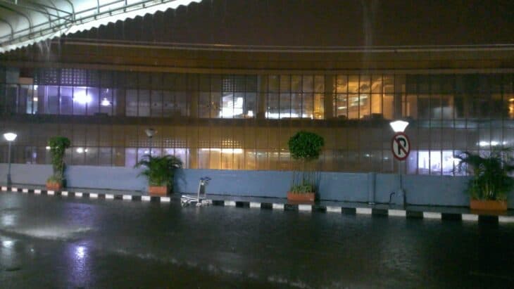 Heavy rain falling outside the terminal at Mumbai airport at night