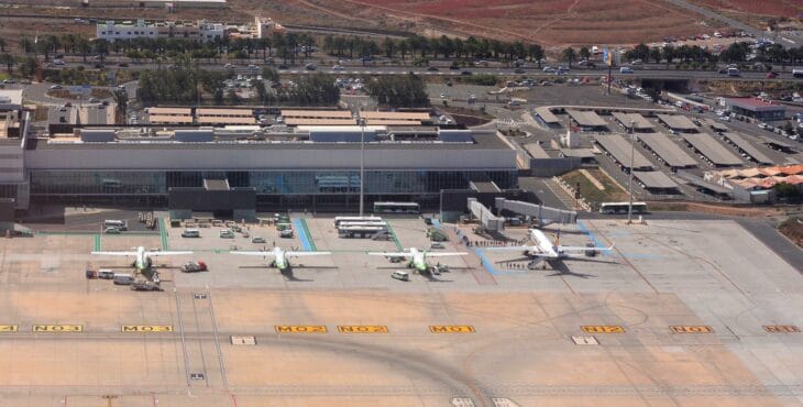 Aerial view of the Gran Canaria Airport terminal and apron with Binter ATRs and a Ryanair 737 parked at the gates