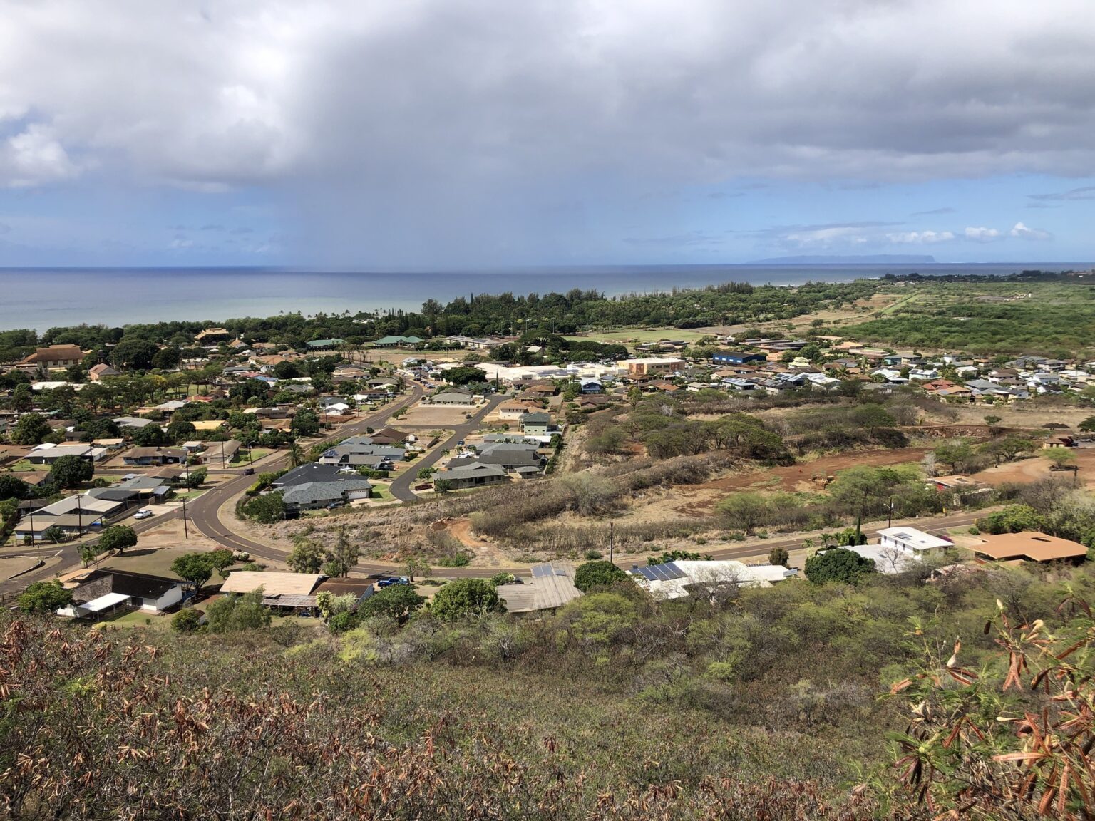 View over the town of Waimea on Kauai's southwest coast, looking toward the ocean from Waimea Canyon Drive