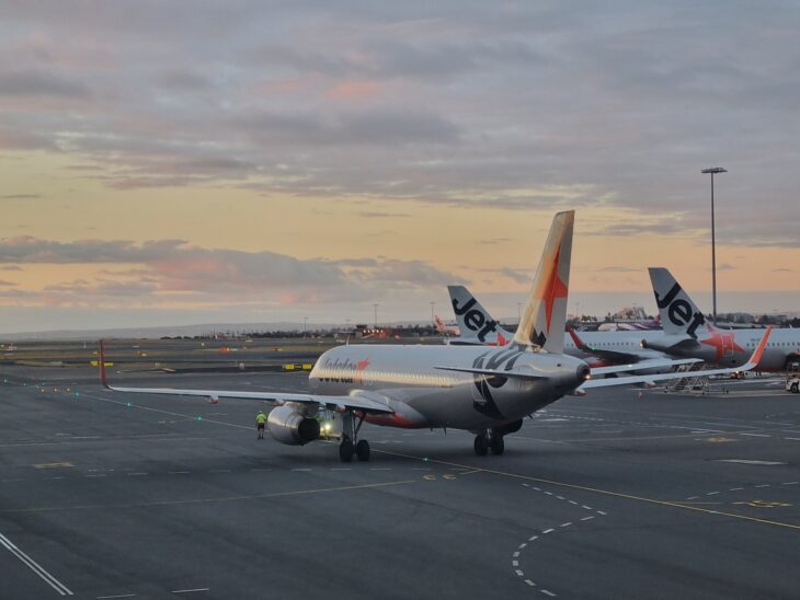 Jetstar Airbus A320 taxiing at Sydney Kingsford Smith Airport at dusk