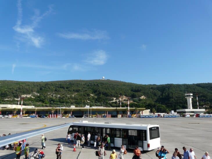 Passengers walking to a bus on the apron at Rhodes Diagoras Airport