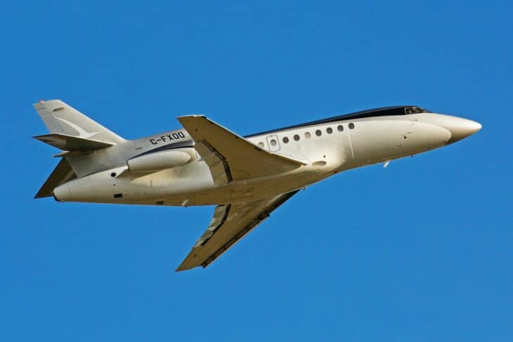 Dassault Falcon 900B C-FXOO banking against a blue sky